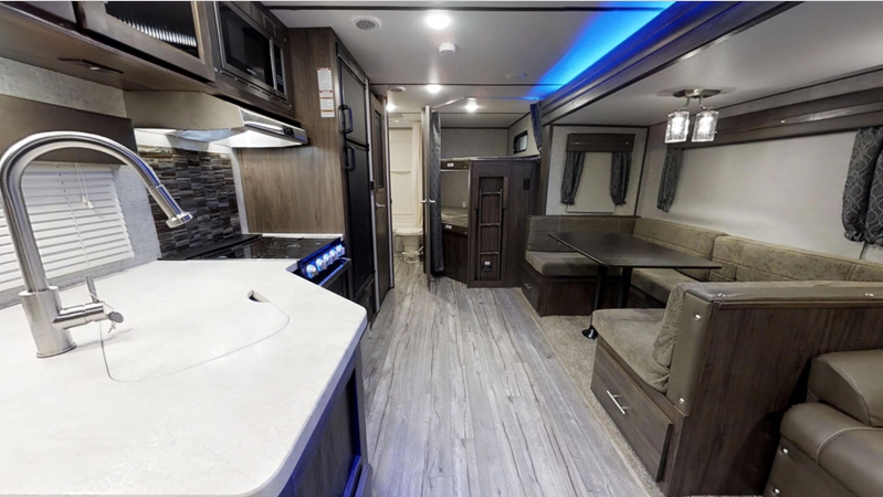 interior view of kitchen and dining alpha wolf travel trailer